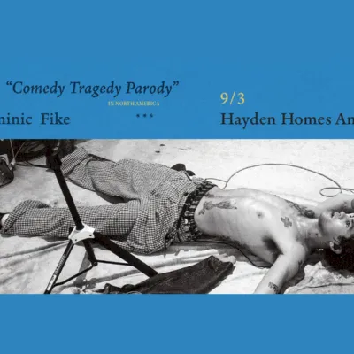 A blue concert-poster banner reads &ldquo;Comedy Tragedy Parody&rdquo; with dates &ldquo;9/3&rdquo; at Hayden Homes Amphitheater, plus a black-and-white photo lying onstage.