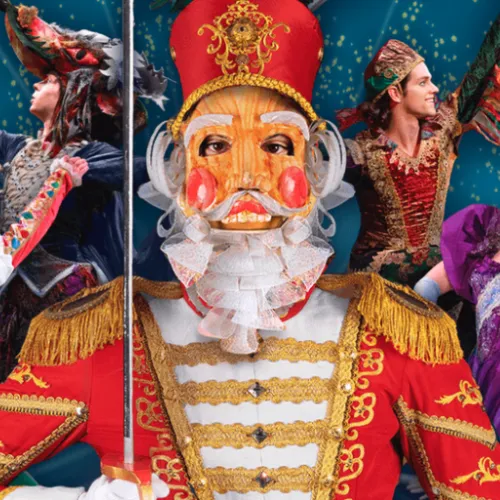 A festive collage of circus-style performers around a central Nutcracker soldier in a colorful celebratory scene.